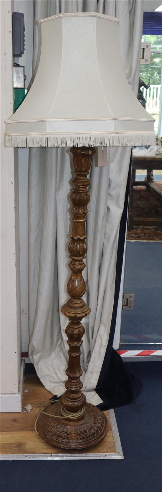 A carved walnut standard lamp